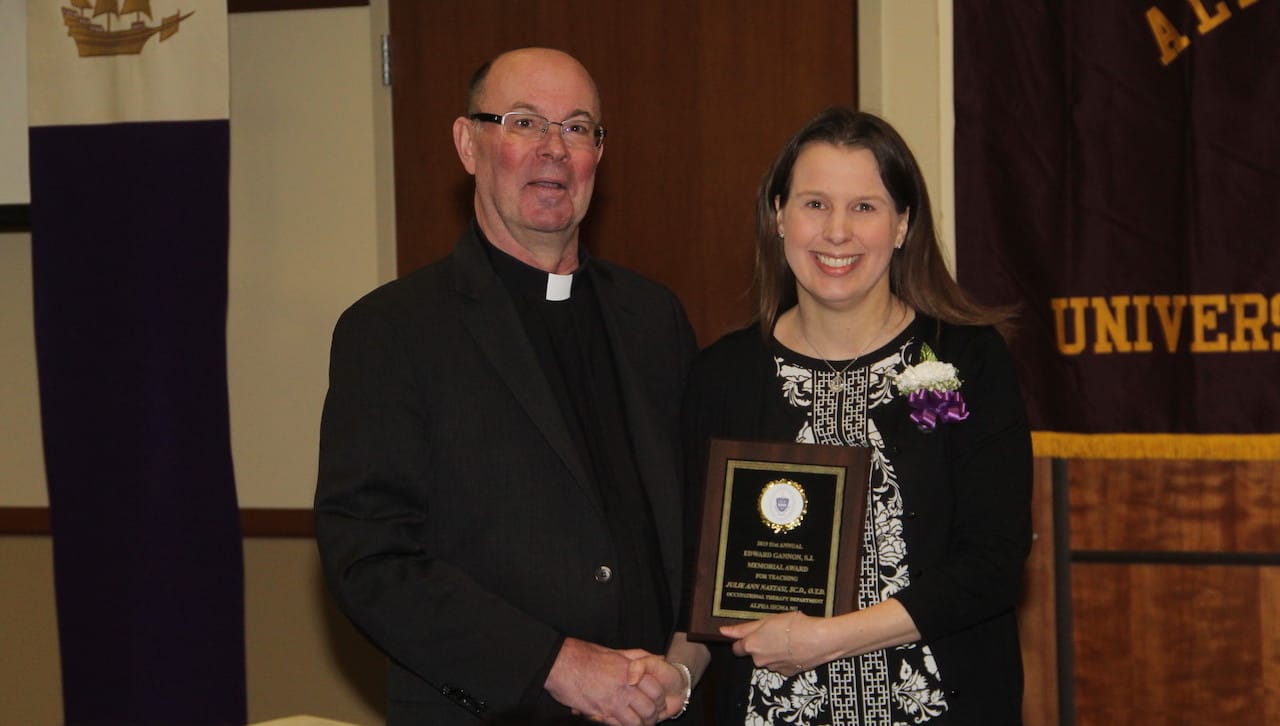 University of Scranton President Rev. Scott R. Pilarz, S.J., congratulates Julie A. Nastasi, Sc.D., O.T.D., assistant professor of occupational therapy, on being named the 2019 Alpha Sigma Nu Teacher of the Year.