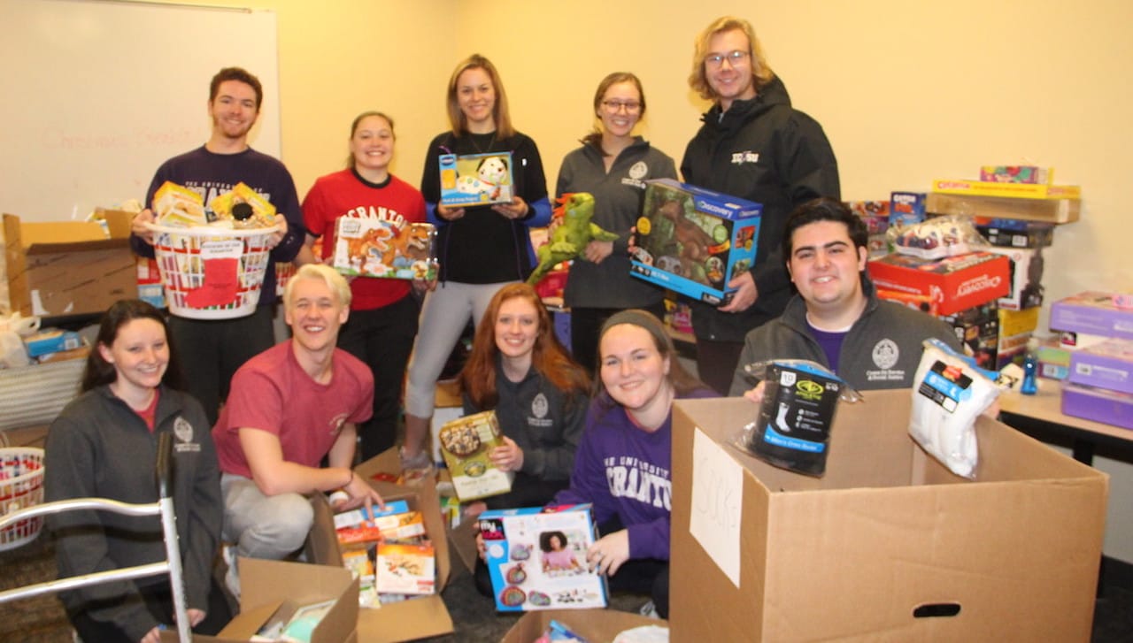 Organizing the hundreds of Christmas gifts donated through drives organized by the Center for Service and Social Justice at the University of Scranton are, front row, from left: Sarah Brown, Dunmore; Stas Postowski, Philadelphia; Maryellen Crain, Beverly, New Jersey; Anna Giannantonio, Milford, New Jersey; and Marino Angeloni, Jessup. Back row: Jack Garvey, Marlton, New Jersey; Kaitlyn Franceschelli, Springbrook Township; Julia Betti, Dickson City; Shannon Everton, Sykesville, Maryland; and Brian Luisi, Ledgewood, New Jersey.
