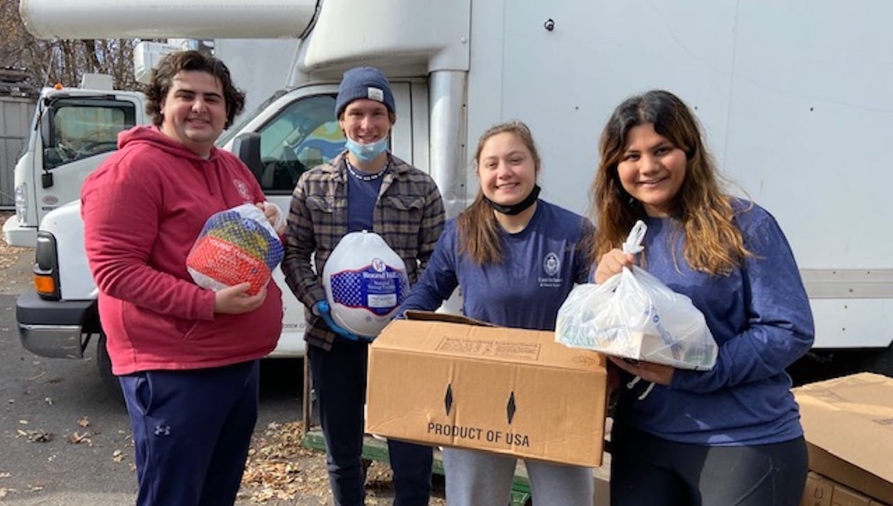 Among the University of Scranton students preparing 125 Thanksgiving food baskets for area families in need are, from left: Marino Angeloni, a counseling and human services major from Jessup; Zach Morrison, a biology major from Shamong, New Jersey; Kaitlyn Franceschelli, a communication major from Springbrook; and Janvee Patel, a health administration major from Scranton. The annual Thanksgiving Food Drive is organized by the University’s Center for Service and Social Justice.