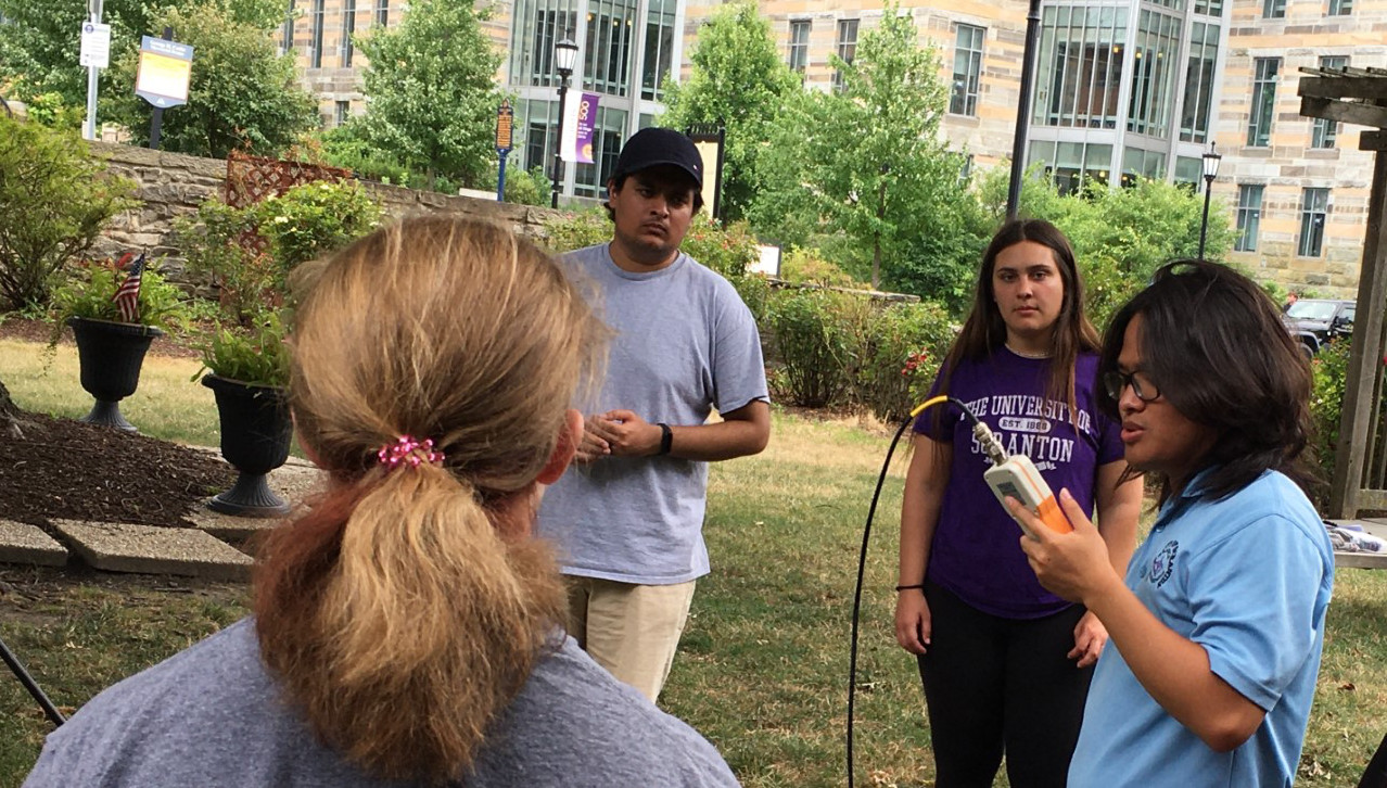 University of Scranton graduate and undergraduate students assist high school students make radio contacts outdoors at The University of Scranton Radio Blaster Physics Summer Camp 