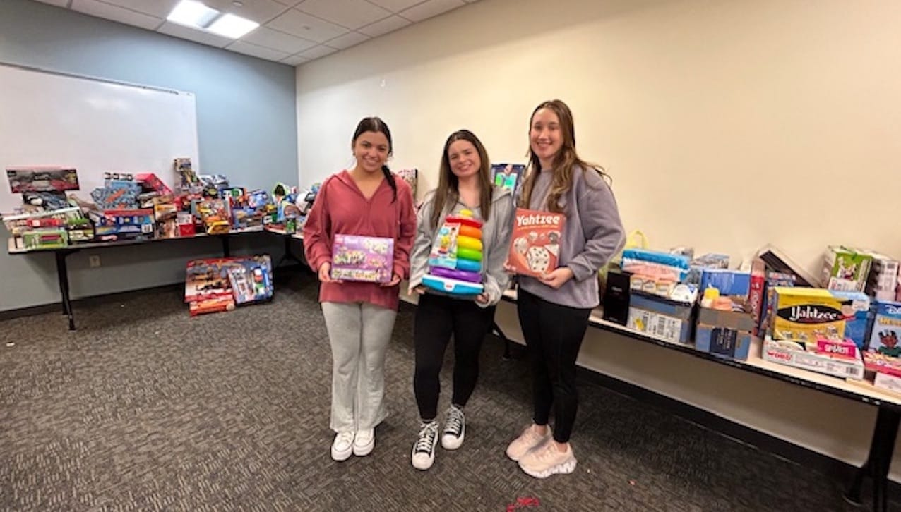 The University of Scranton’s Center for Service and Social Justice collected hundreds of donated toys for area children through annual Christmas giving programs on campus. Sorting through the donated items are, from left, University students Sophia Pisarski, a business analytics major from Jessup, Abigail Casal, an early and primary teacher education major from South Abington Township, and Zoe Honney, a cybercrime and homeland security major from Scranton.