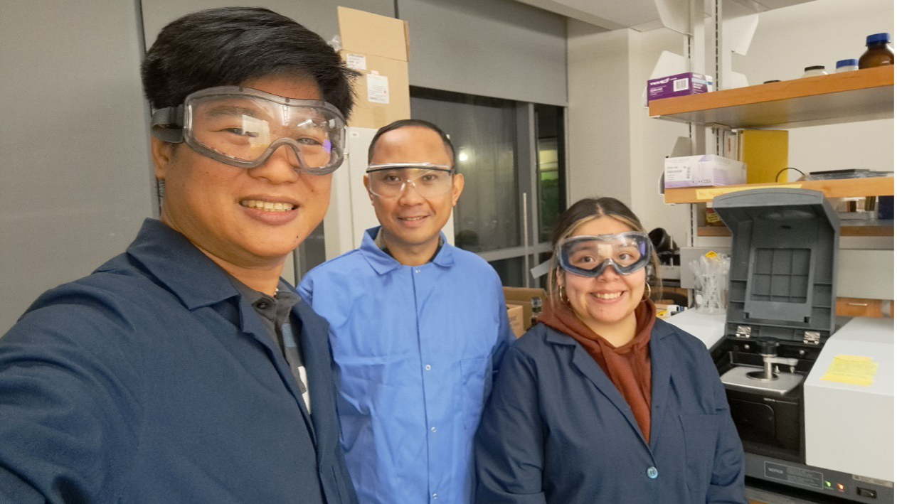 MS Biochemistry graduate students, Norwell Bautista, left, and Noemi Carreto, right, perform research in the chemistry laboratory space at the Loyola Science Center. These students are being mentored by Dr. Gerard Dumancas, center.
